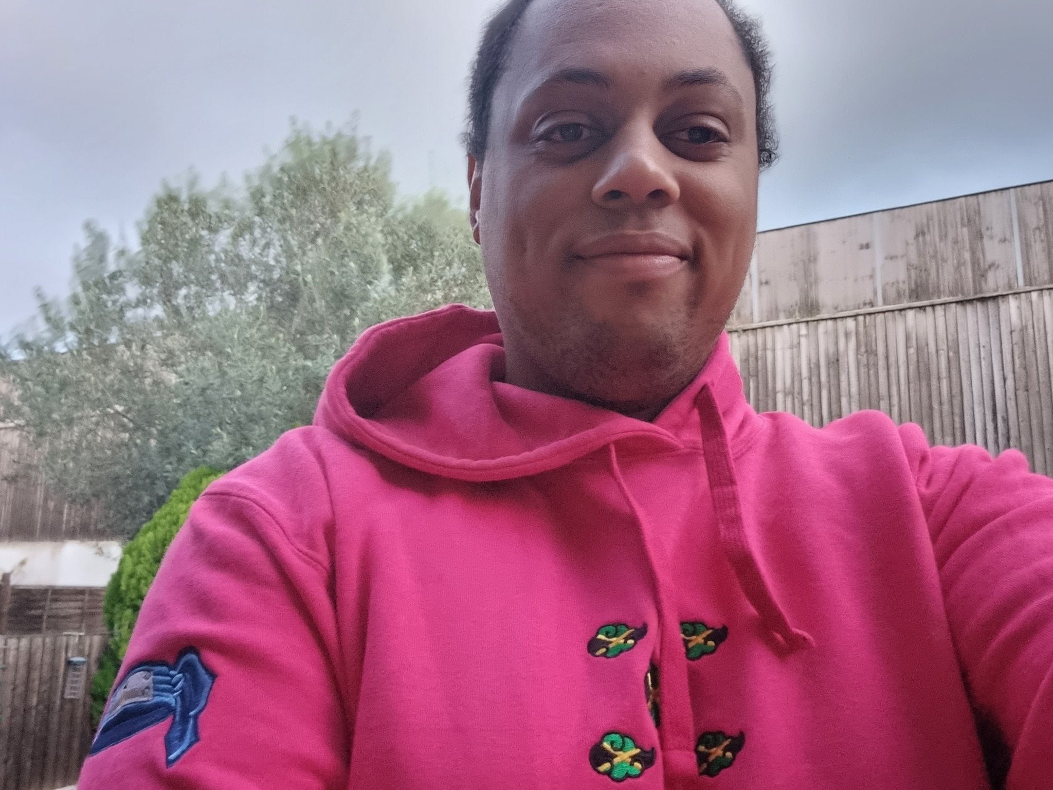 Linley in a Pink Hoodie with Tee's Caribbean Jamaican Akatsuki Cloud Embroidered Design 