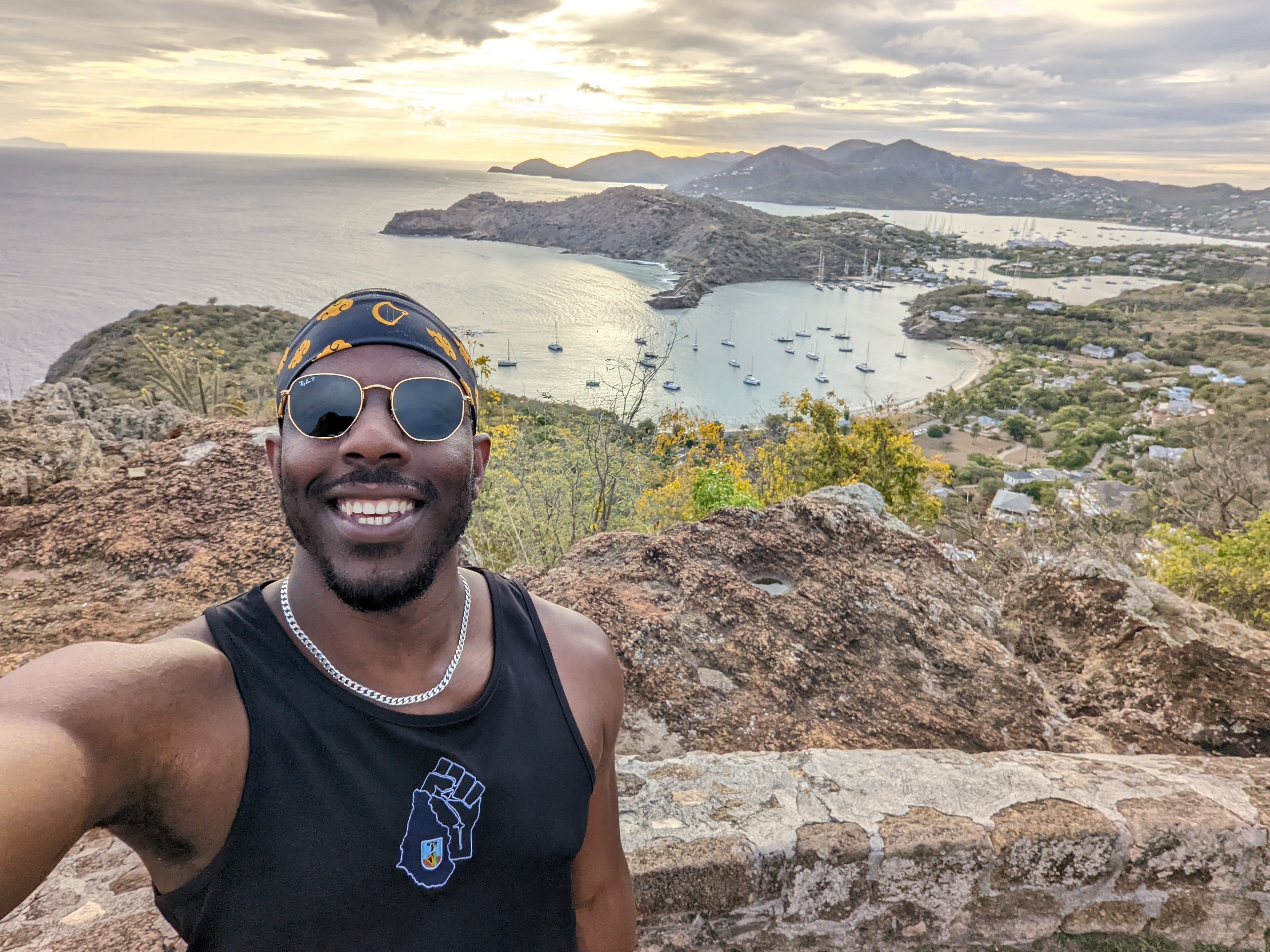 Founder of Tee's Caribbean in a Montserrat Power Fist Vest in Antigua at the top of Shirley Heights